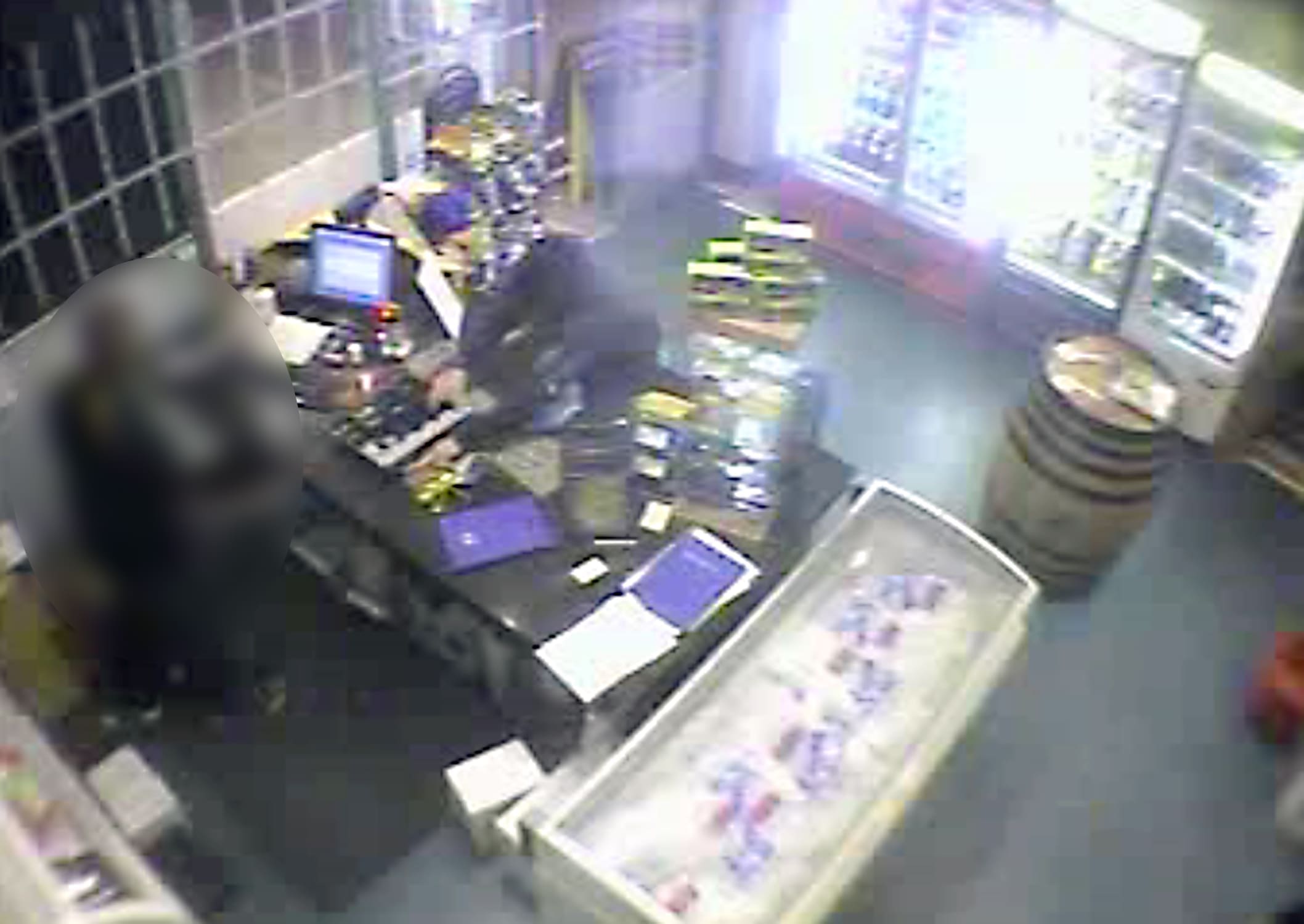 Braddon aggravated robbery 29.12.09 CCTV image of the offender taking money from the cash till.